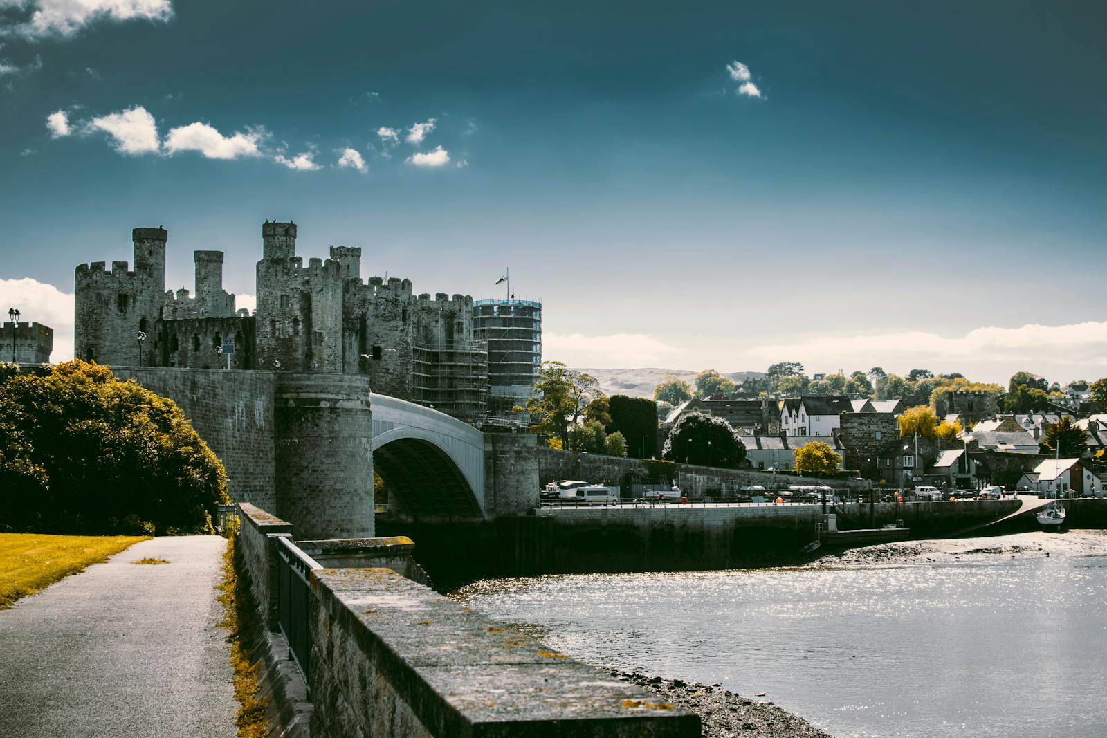Historic castle with bridge over river, scenic view of medieval architecture and surrounding landscape
