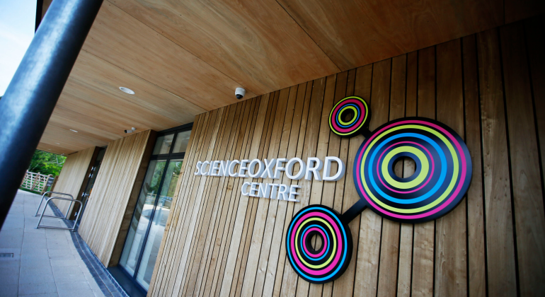 Science Oxford Centre entrance with colourful circular design on wooden exterior wall