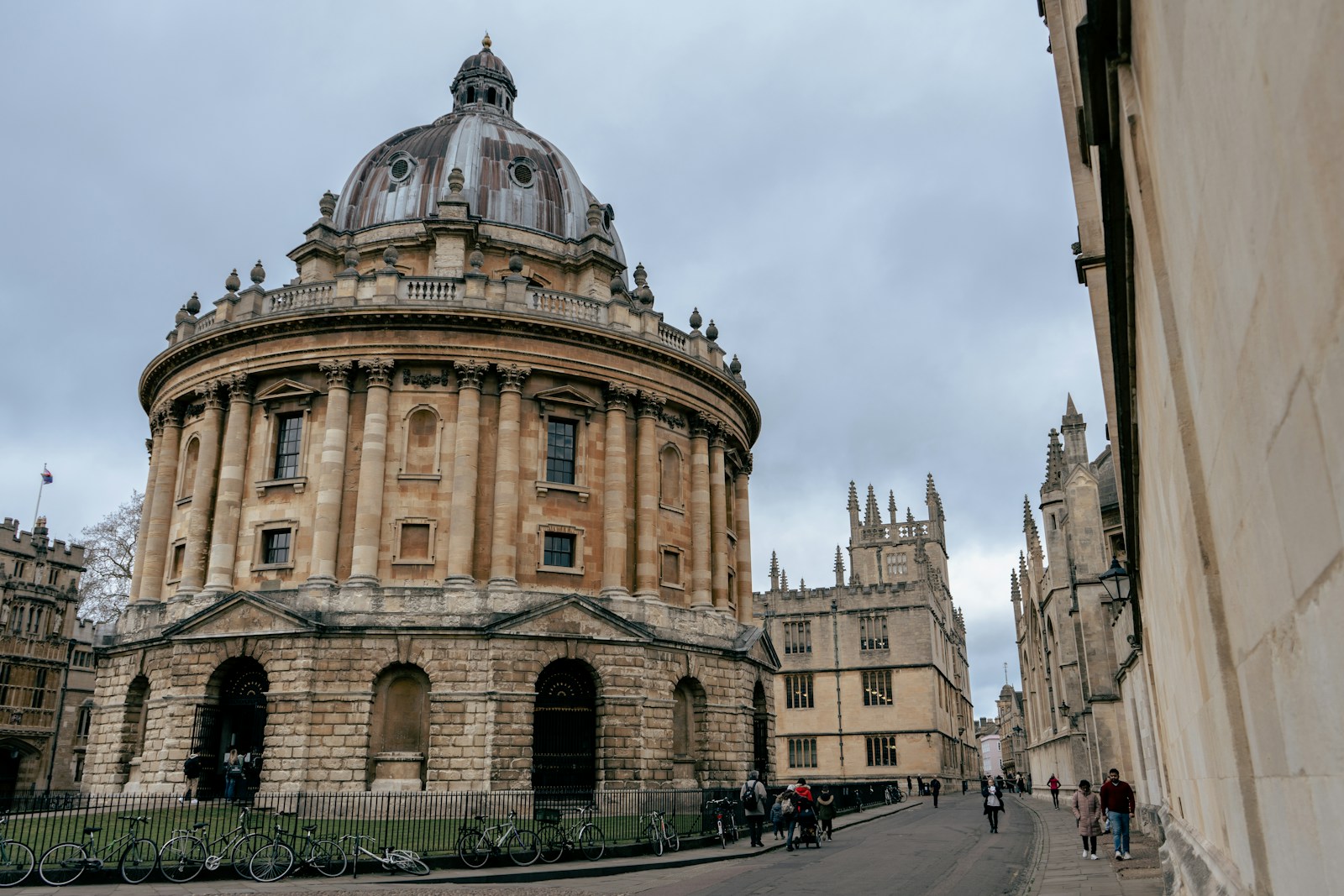 Historic Radcliffe Camera and vibrant street scene in Oxford UK on a cloudy day